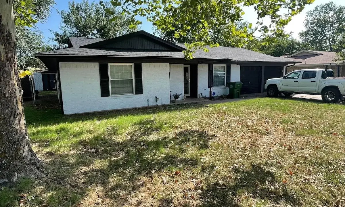 Professional roofing crew working on a residential roof in Iowa Colony